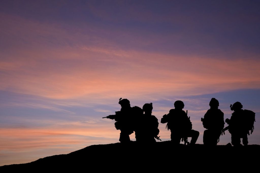 Soldier Silhouettes Against Sunset