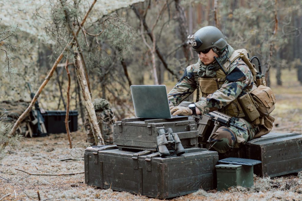 Soldier In Woods With Laptop And Gear