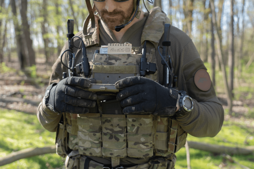 Soldier in forest using smart device